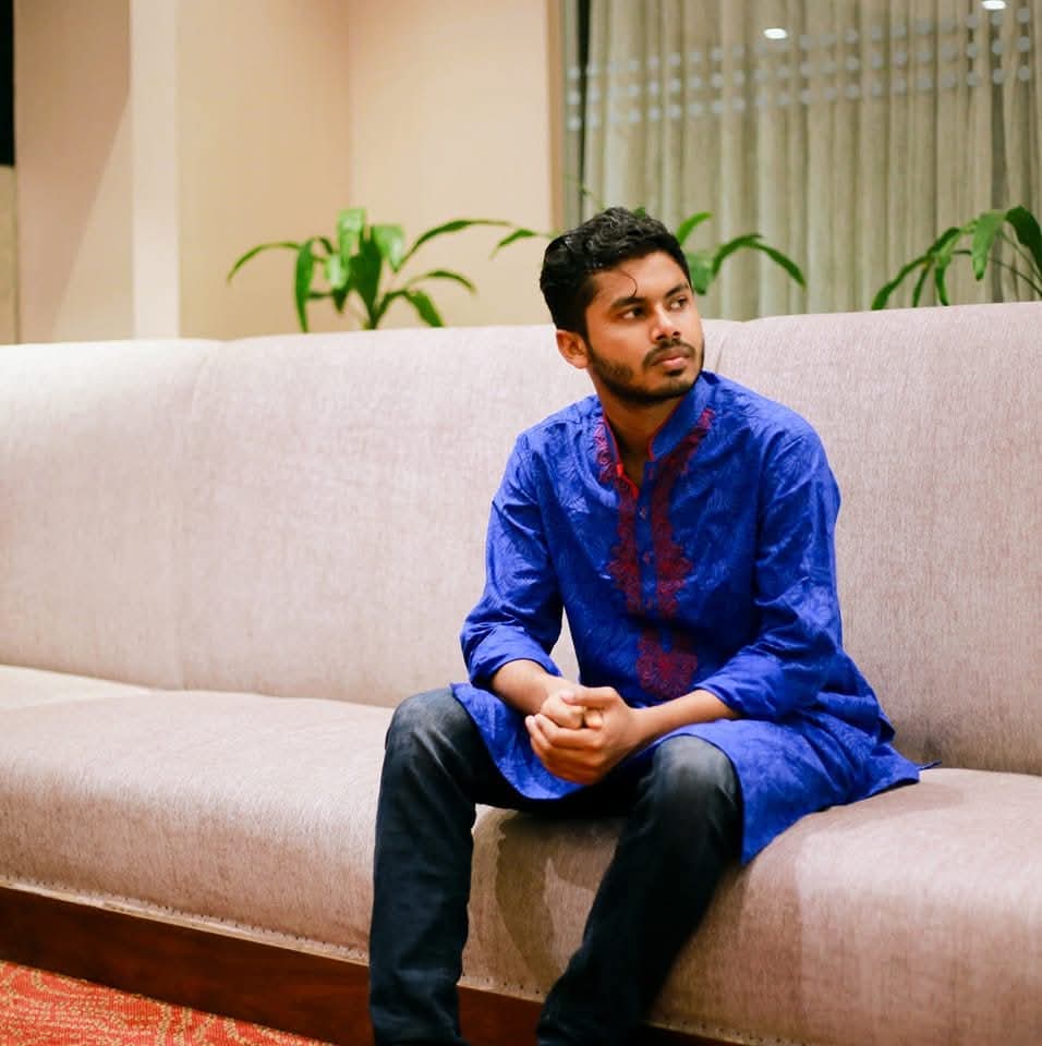 Mohsin Hossain seated indoors